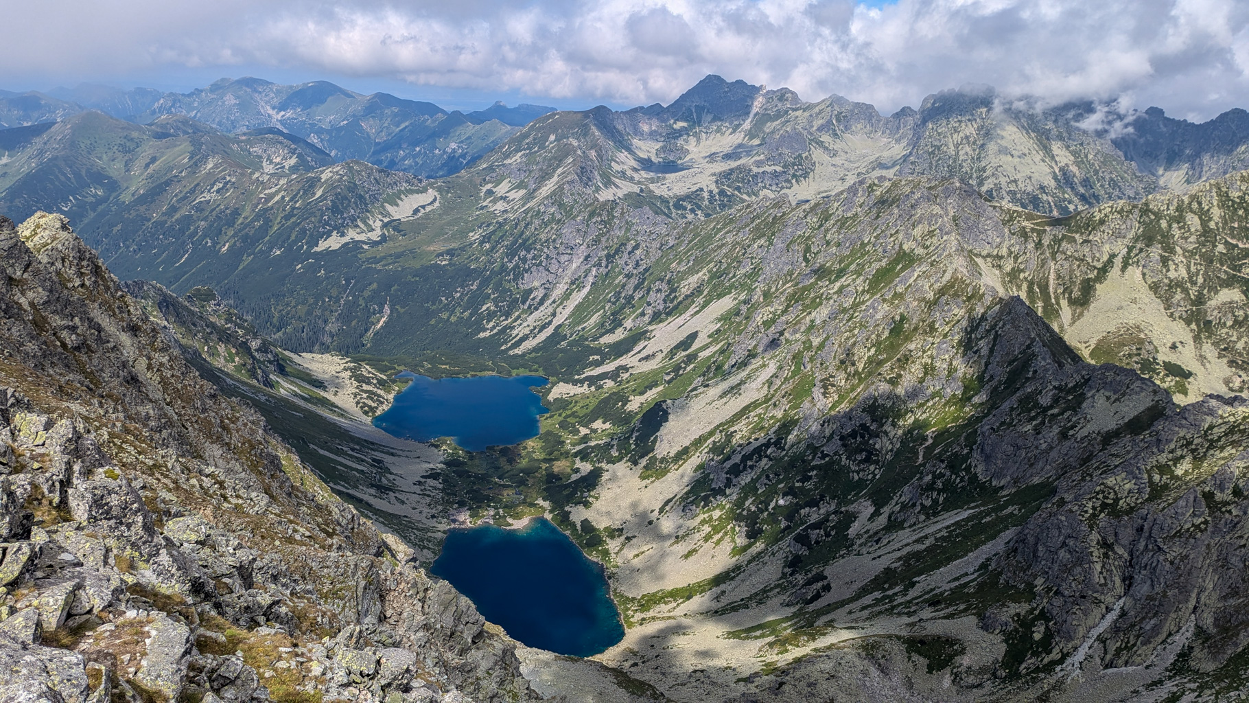 Panoramatický pohľad z vrcholu Kôprovského štítu na Temnosmrečinské plesá a v pozadí časť poľských Tatier.